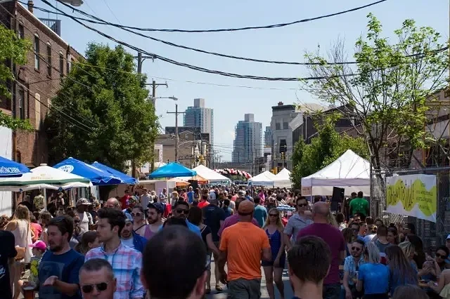 Imae depicts the lively neighborhood of Fishtown during a street festival, located close to The Avenue in Fishtown