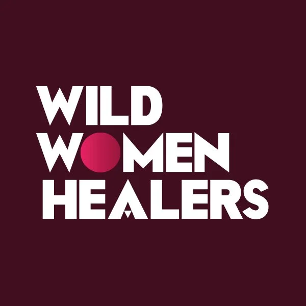 Logo with bold white text reading "Wild Women Healers" on a dark maroon background, with a pink circle replacing the letter "O" in "Women."