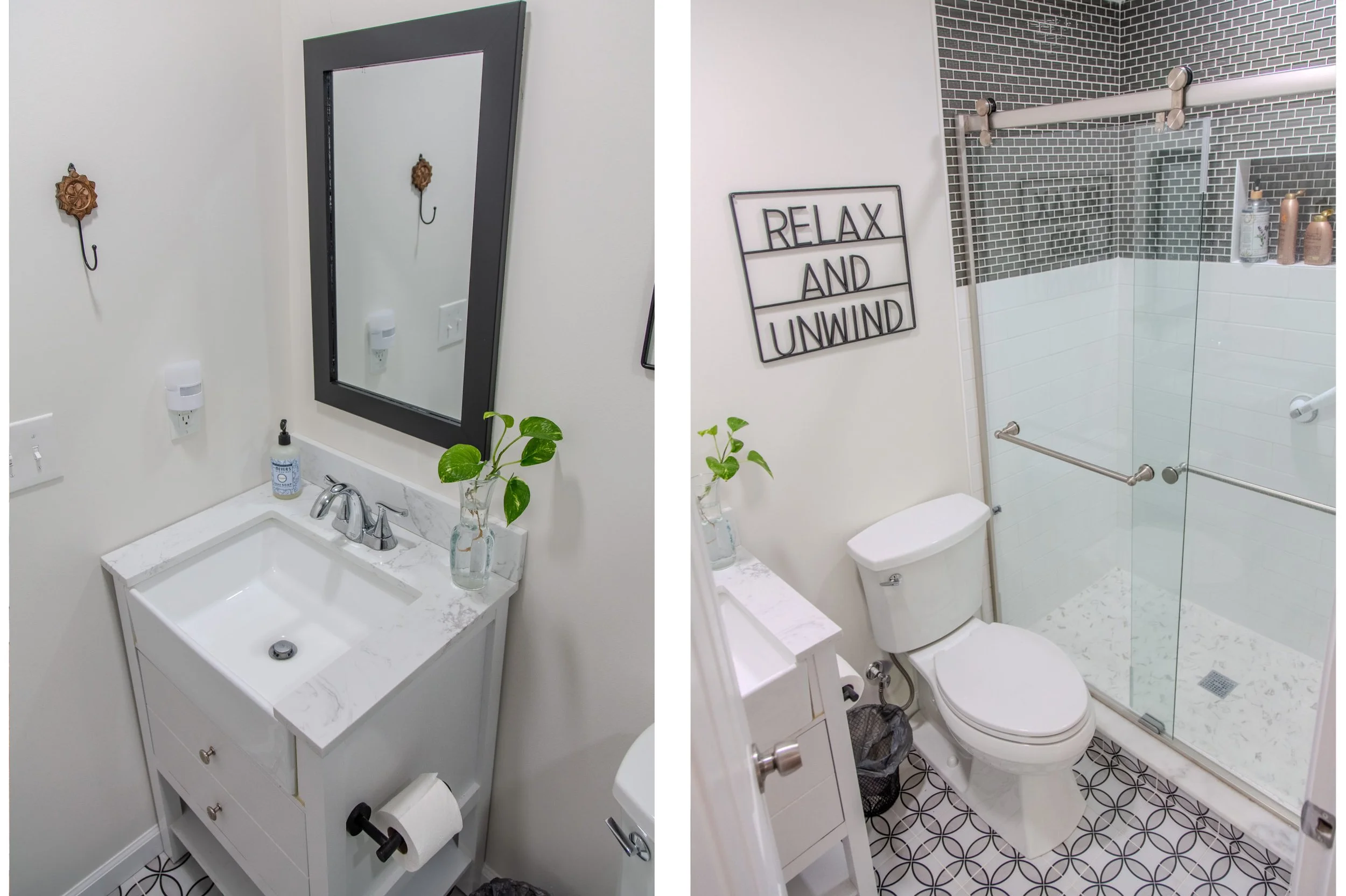 A bathroom with a white vanity and marble top, mirror, and small plant, on the left. The right side shows a toilet, a glass shower enclosure, wall decor reading 'Relax and Unwind', and patterned floor tiles.