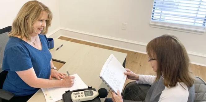 voice therapist treating an adult patient