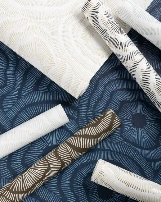 Various fabrics with geometric circular patterns in white, navy, brown, and cream colors