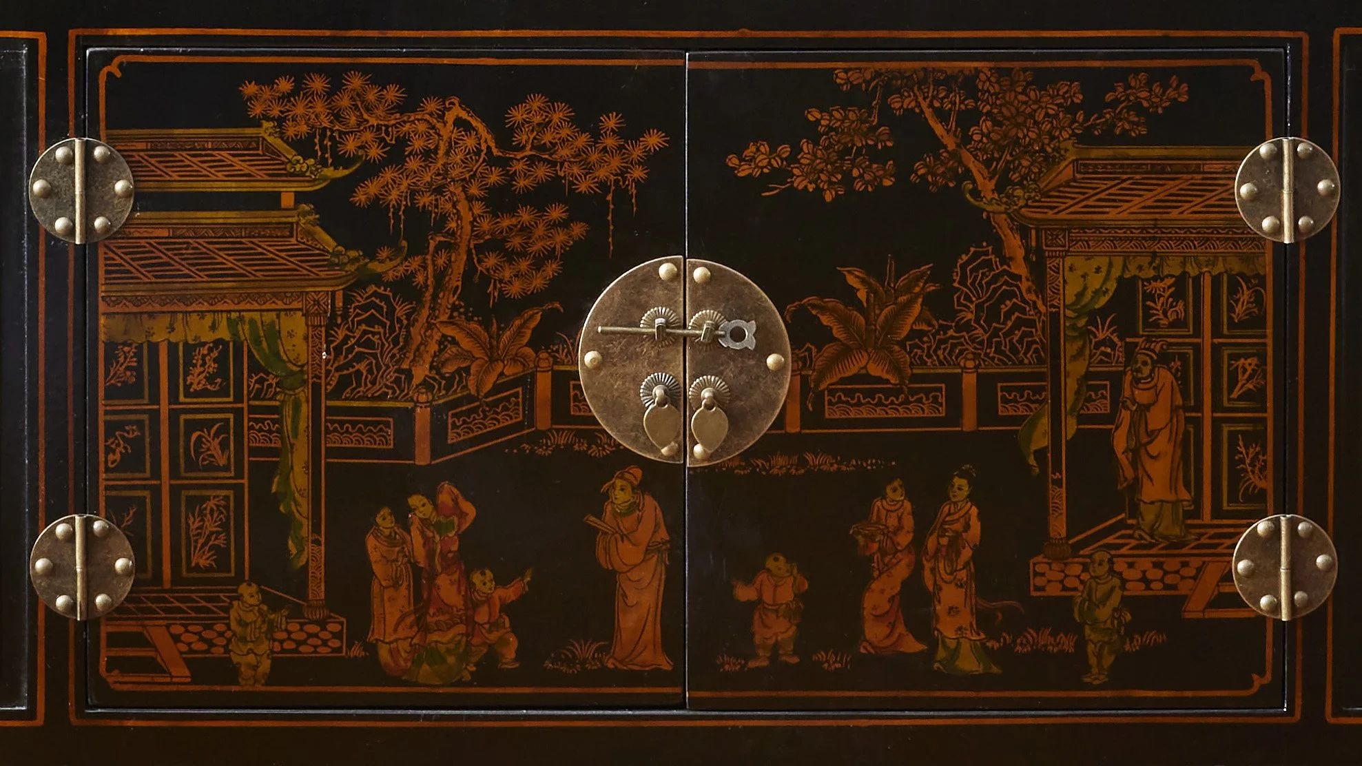 Decorative Asian-style cabinet with intricate orange and black landscape and figures design, metal hinges, and central lock.