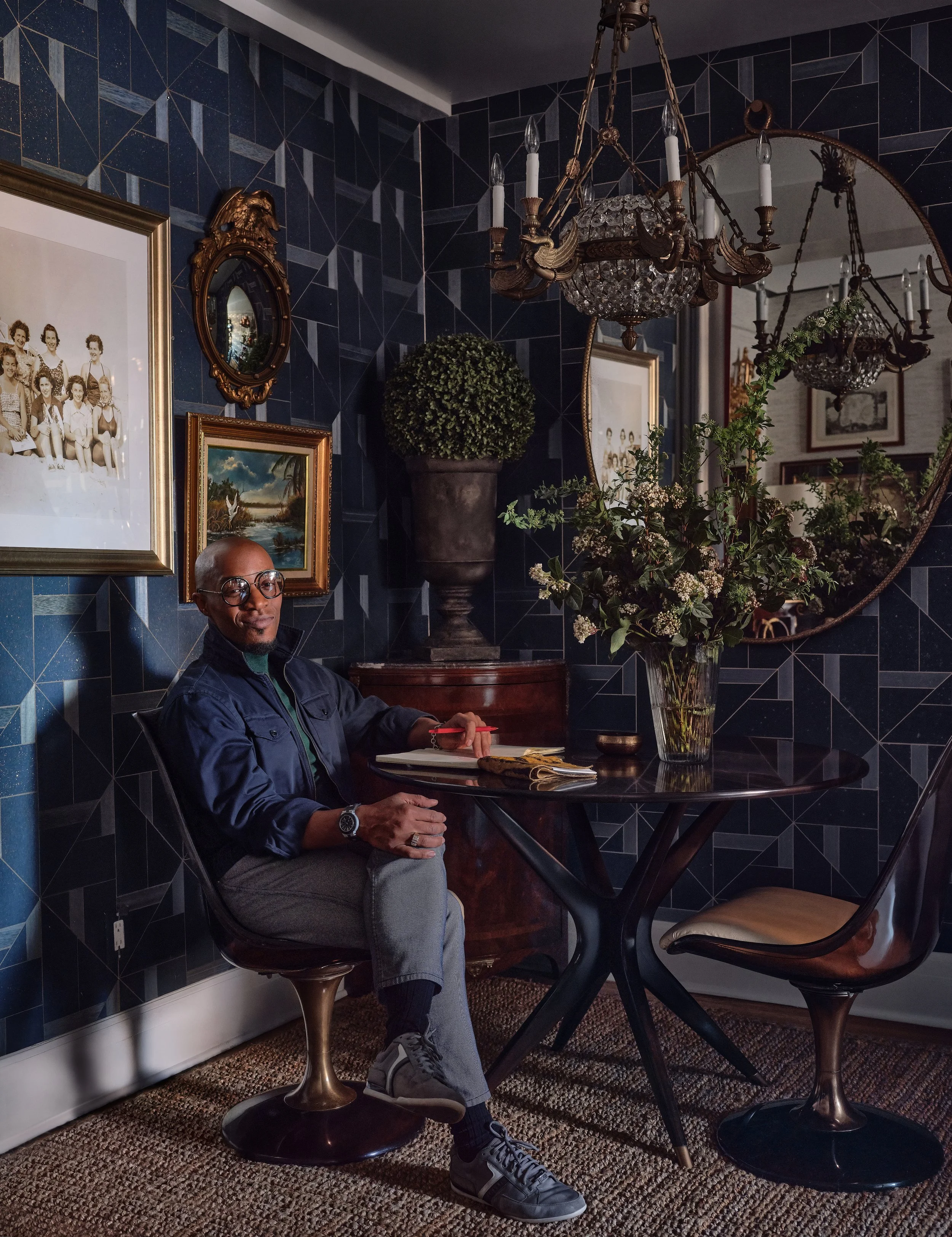 Corey Damen Jenkins sitting at a wooden breakfast table in his New York City condo