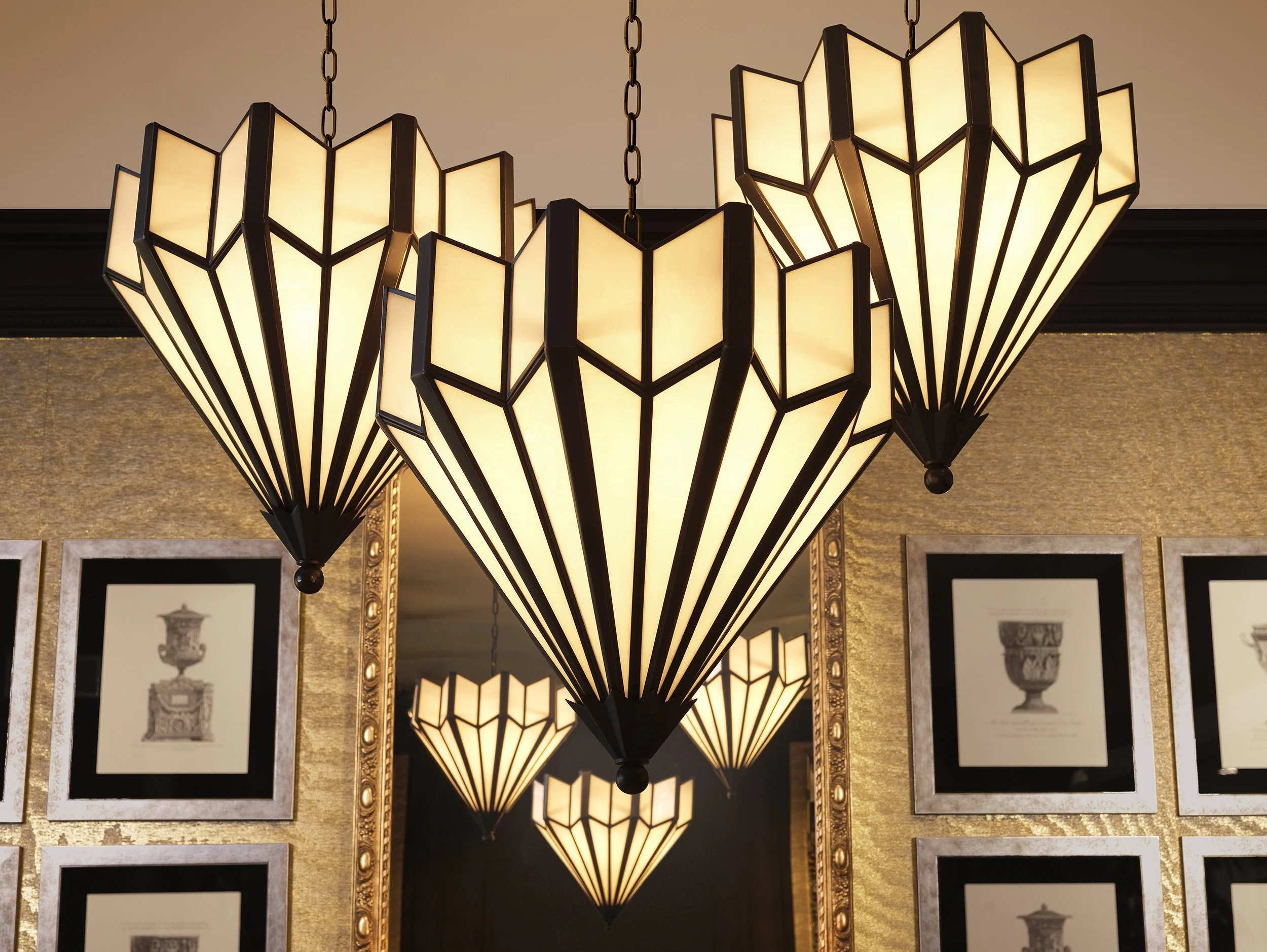 A large, geometric chandelier with multiple triangular lamp shades hanging from chains.