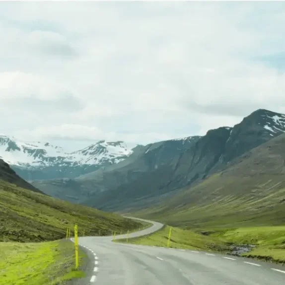 An empty mountain road stretching forward, representing the journey toward lasting relief.