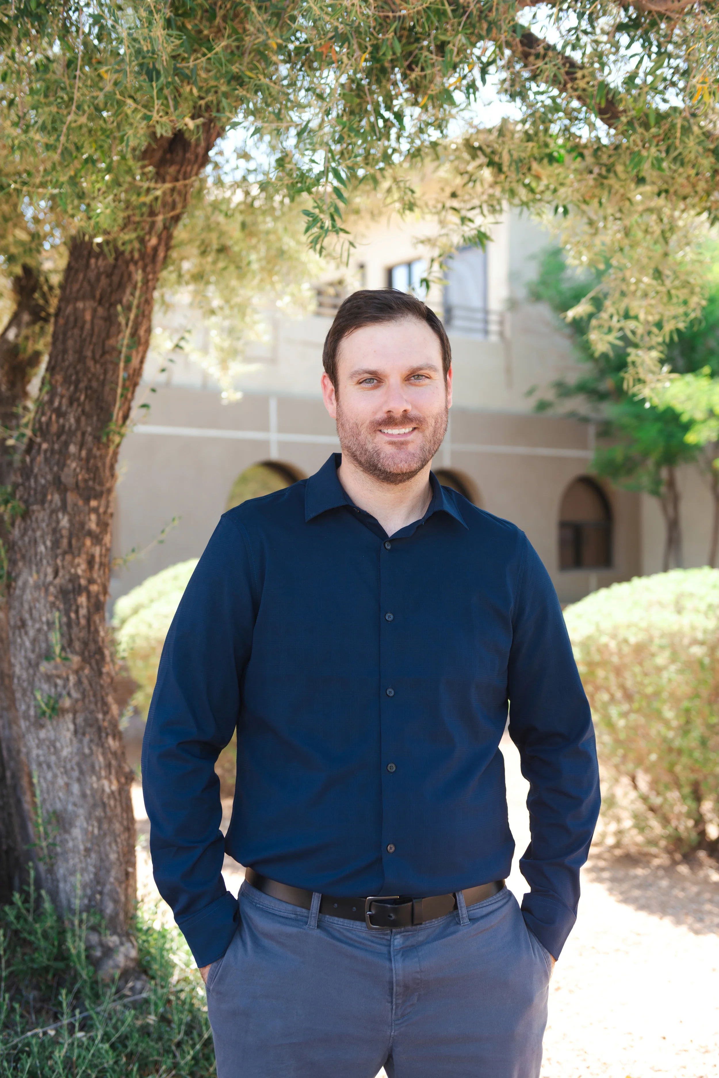 Michael Tugendhat, LCSW, smiling in a navy shirt. Telehealth trauma therapist in Scottsdale.