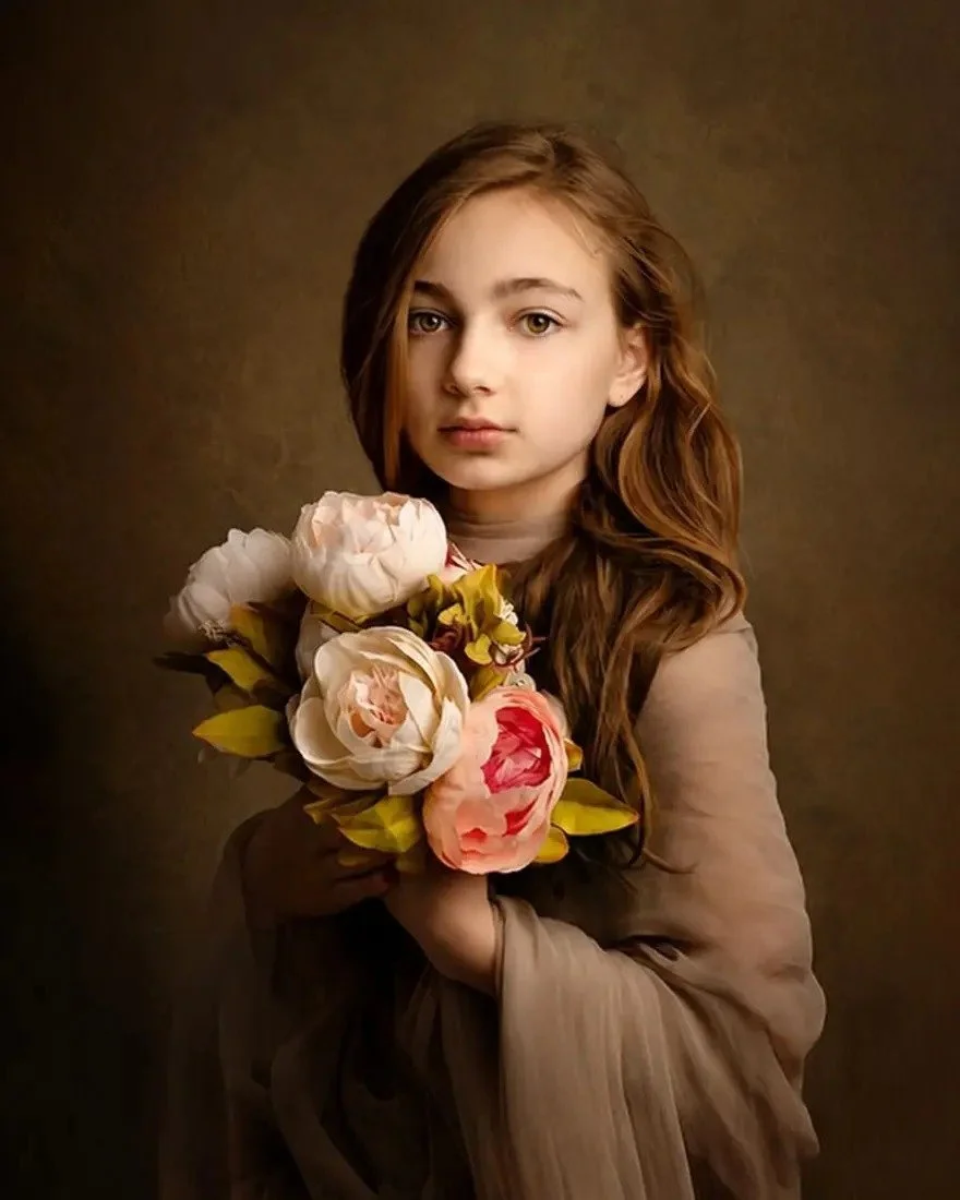 Fine art portrait of a child holding a bouquet of flowers