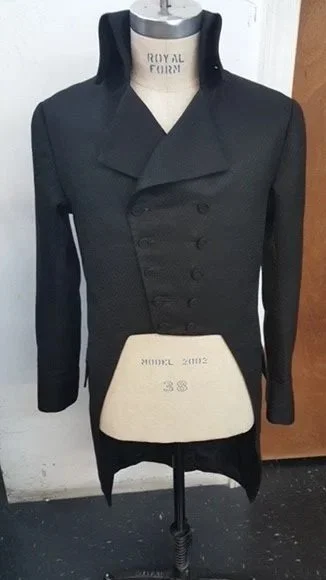 Black coat with wide lapels and double-breasted buttons