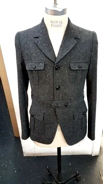A dark gray, double-breasted blazer with front flap pockets.