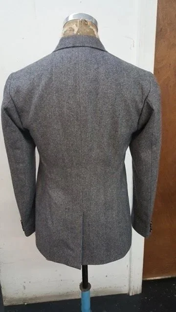 Gray blazer with a notch lapel.