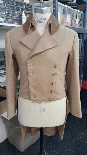 A beige double-breasted coat with wide lapels