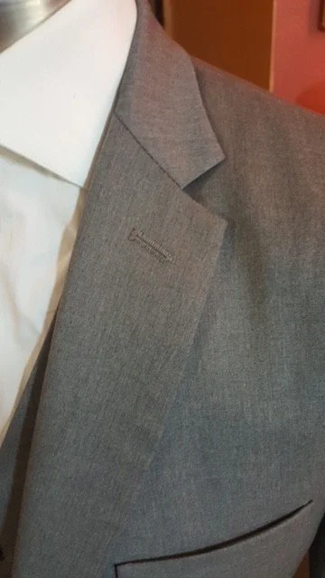 Close-up of a gray suit jacket over a white shirt