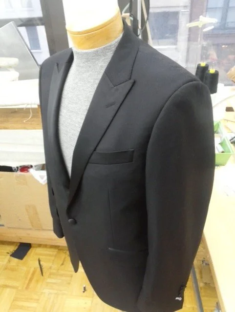 Black suit jacket and a gray shirt.