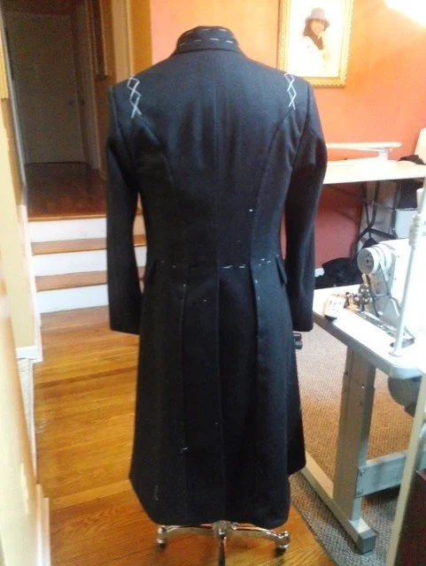 Back view of a long black coat