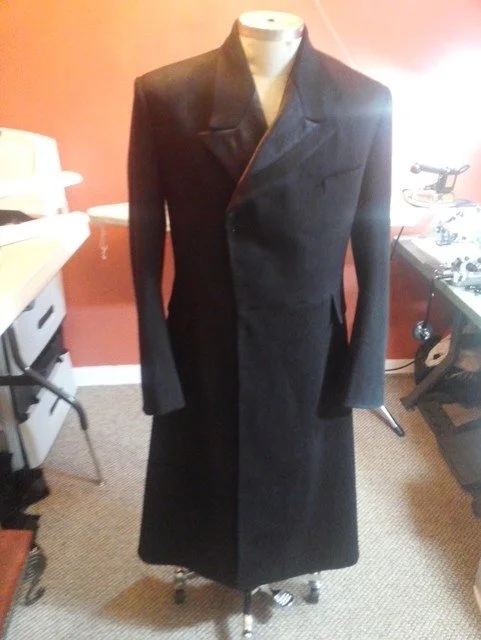 Black tailored overcoat.
