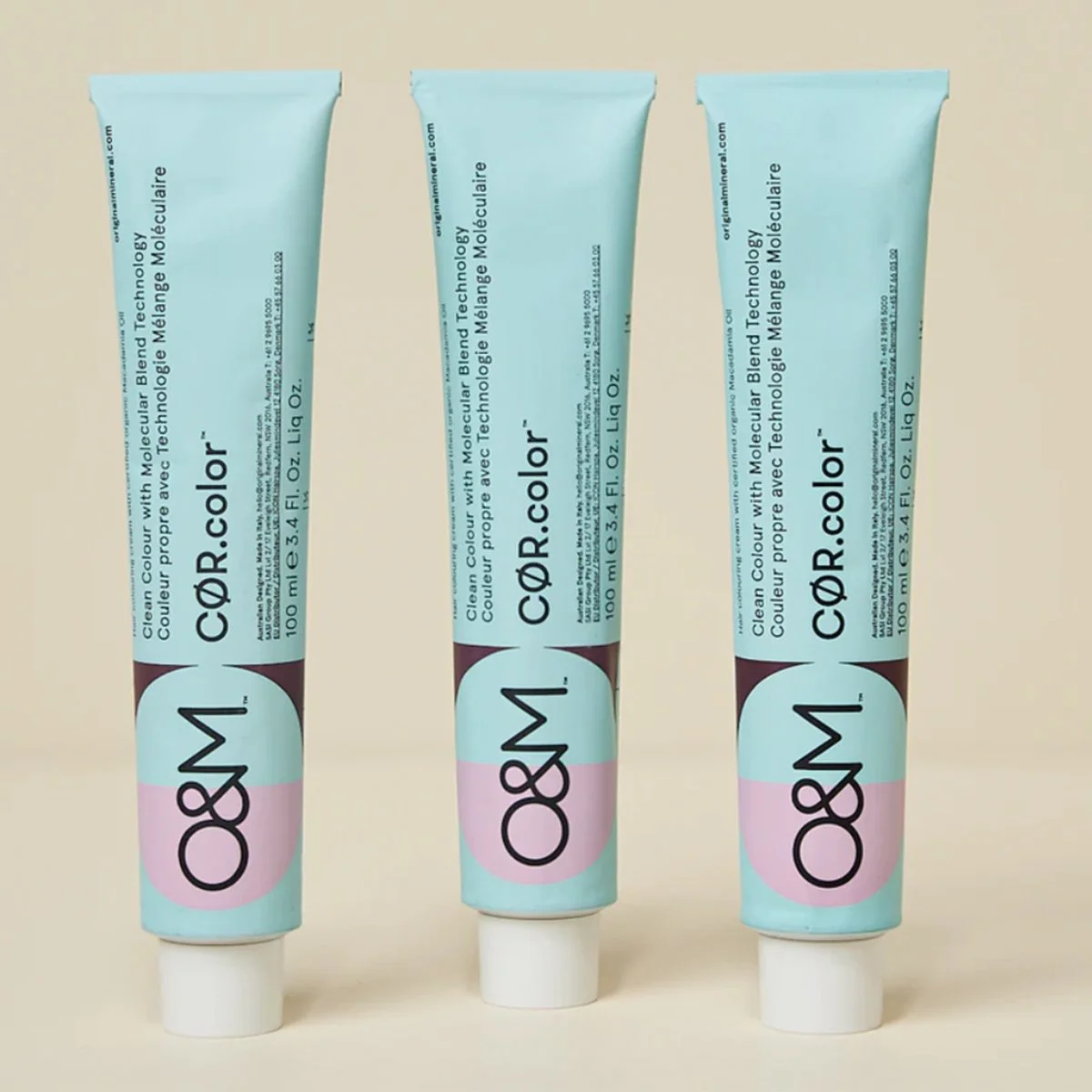 Three tubes of Dr. Color skincare cream standing upright on a light surface with a simple background.