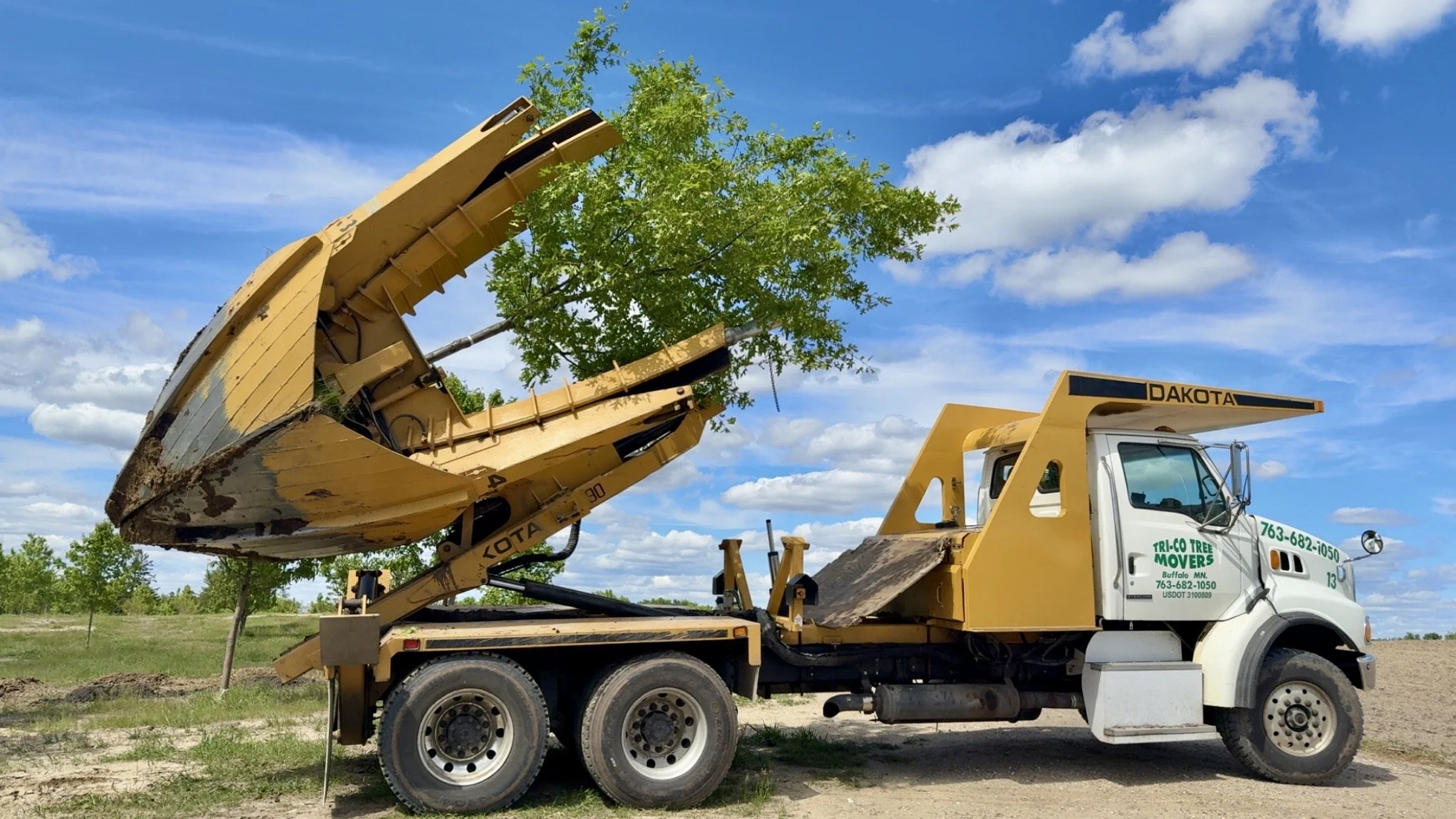 Large tree spade equipment used by Tri-Co Tree Movers to transplant mature trees in Minnesota