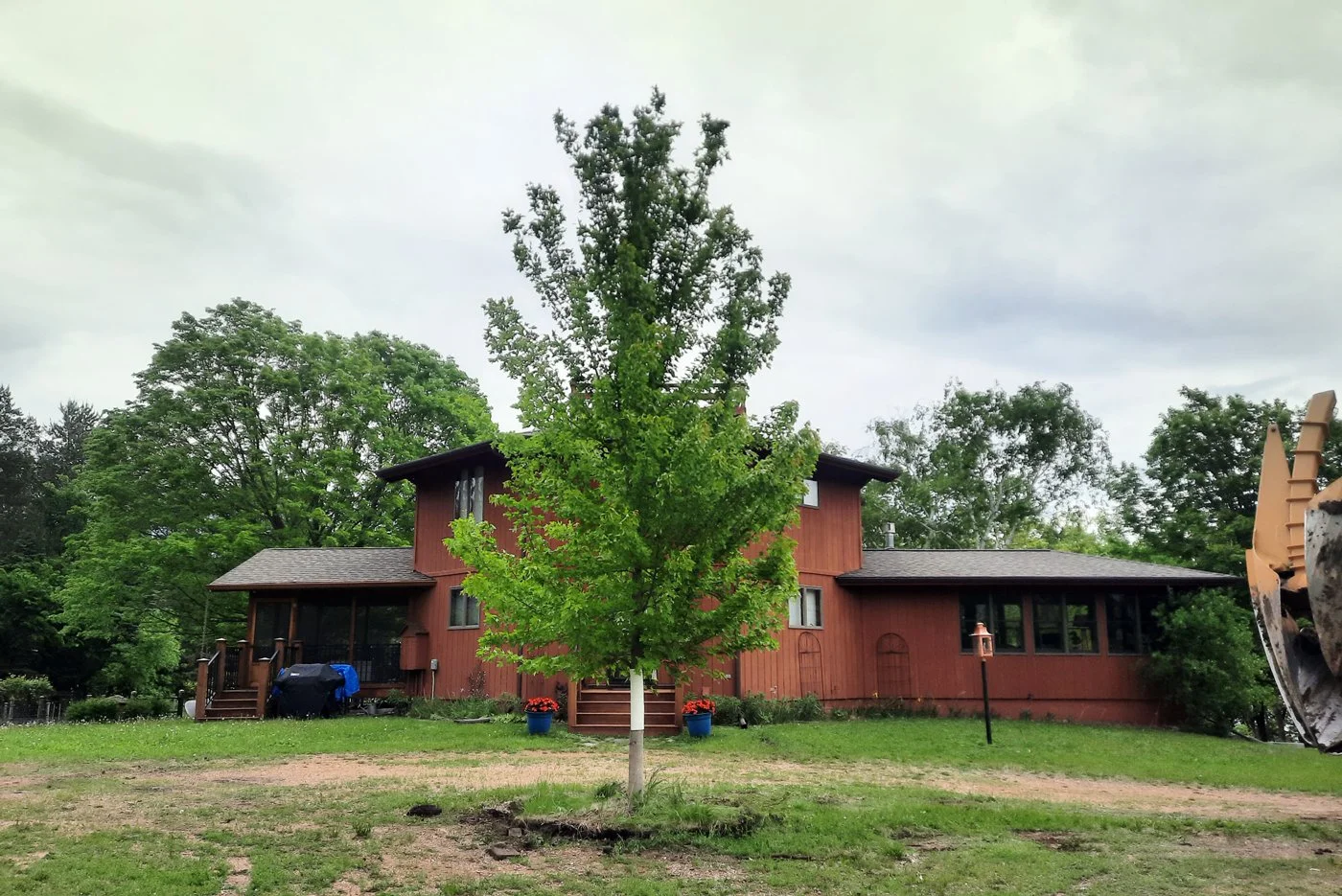 Tree transplanting service by Tri-Co Tree Movers planting a mature tree on a Minnesota property
