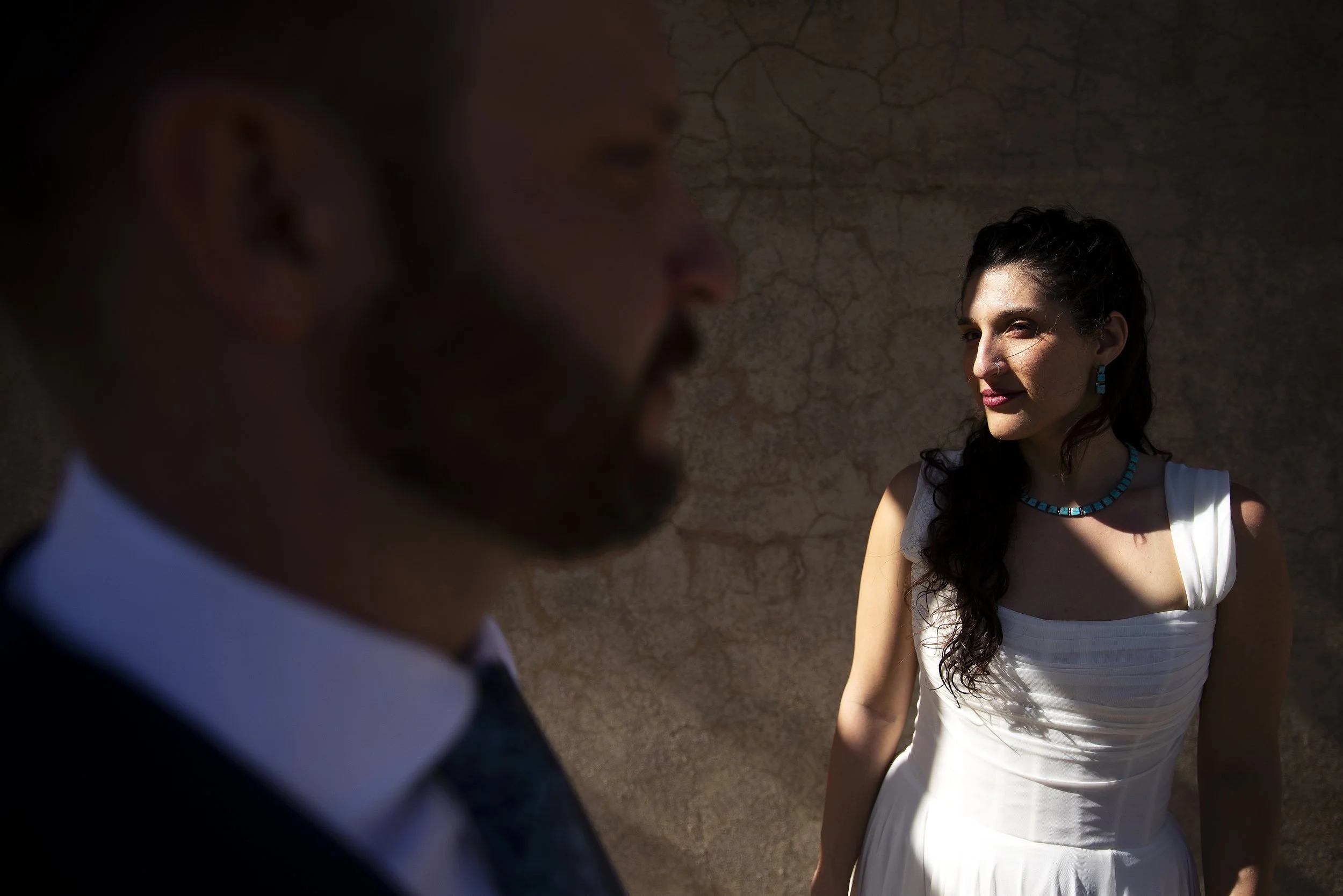 A bride and groom are portrayed before their wedding ceremony at the Little Daisy, a wedding venue in Jerome, Arizona, photographed by Megan Farmer, a documentary style wedding photographer based in Seattle, Washington. 
