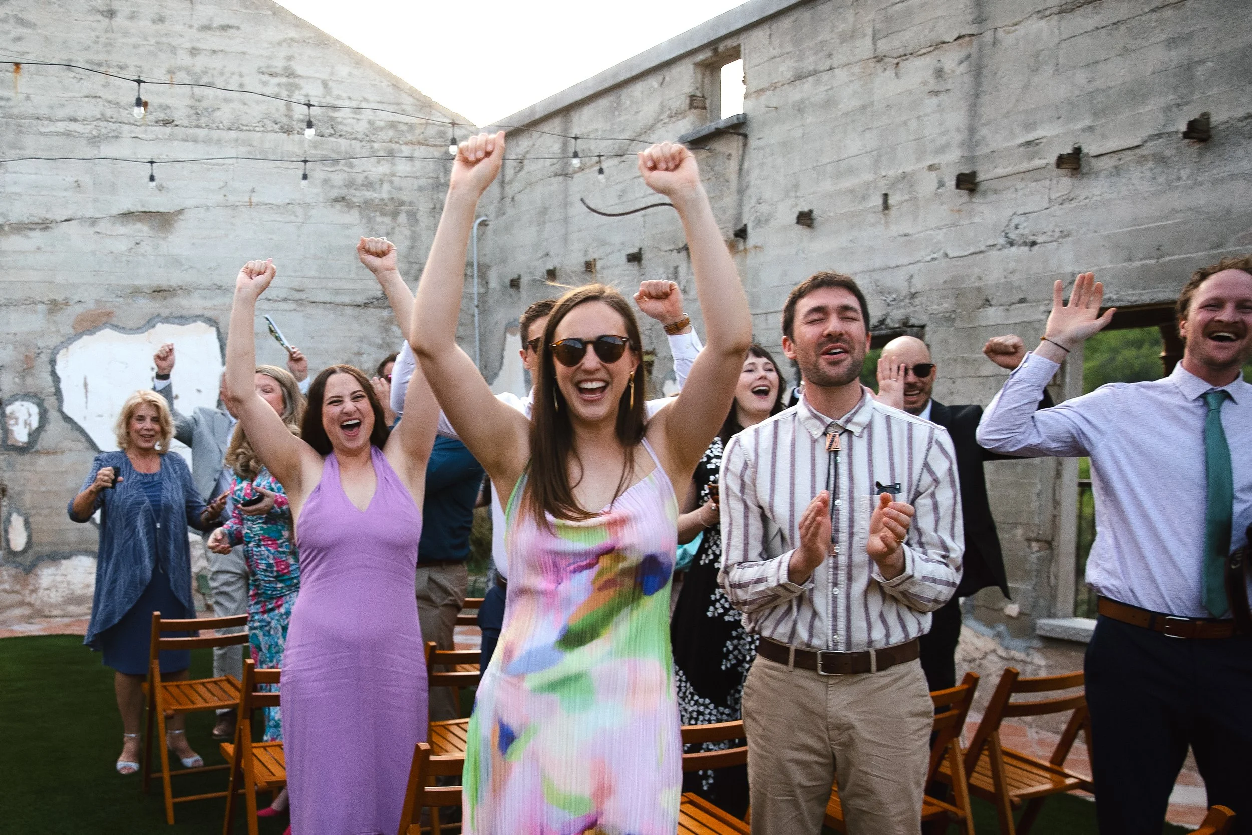 Friends celebrate, cheer and clap for the bride and groom following their wedding ceremony photographed by Megan Farmer, a documentary style wedding photographer based in Seattle, Washington. 
