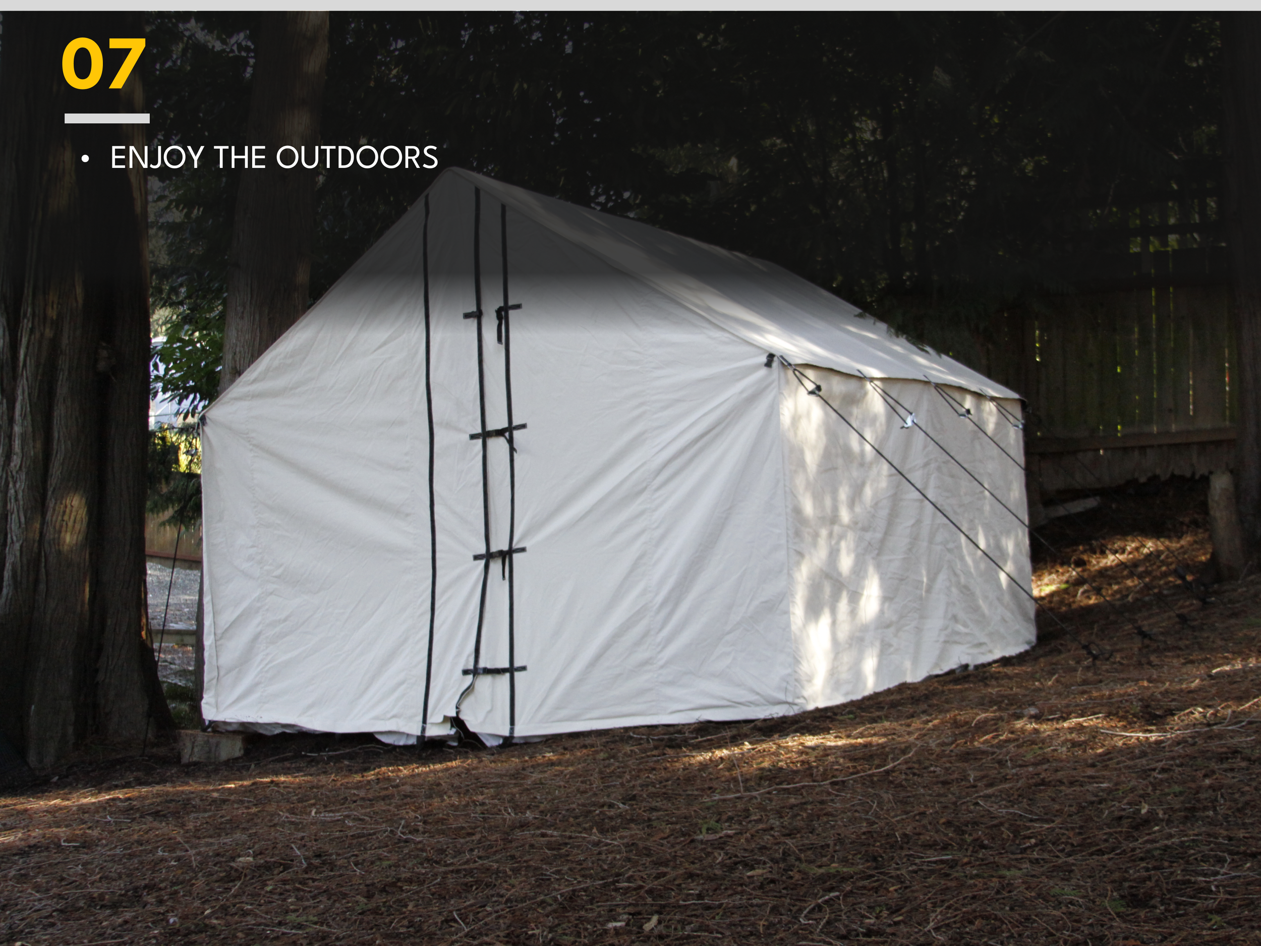 A white outdoor tent set up on a forest ground surrounded by trees, with the text '07 ENJOY THE OUTDOORS' overlaid.