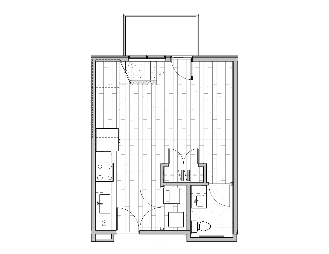 Floor plan of a small apartment with a kitchen, bathroom, living area, and staircase leading upstairs.
