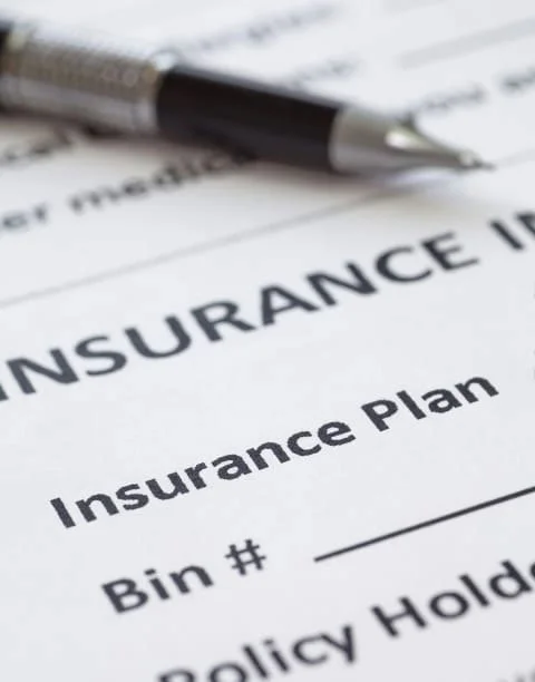Pen on top of dental insurance plan form.