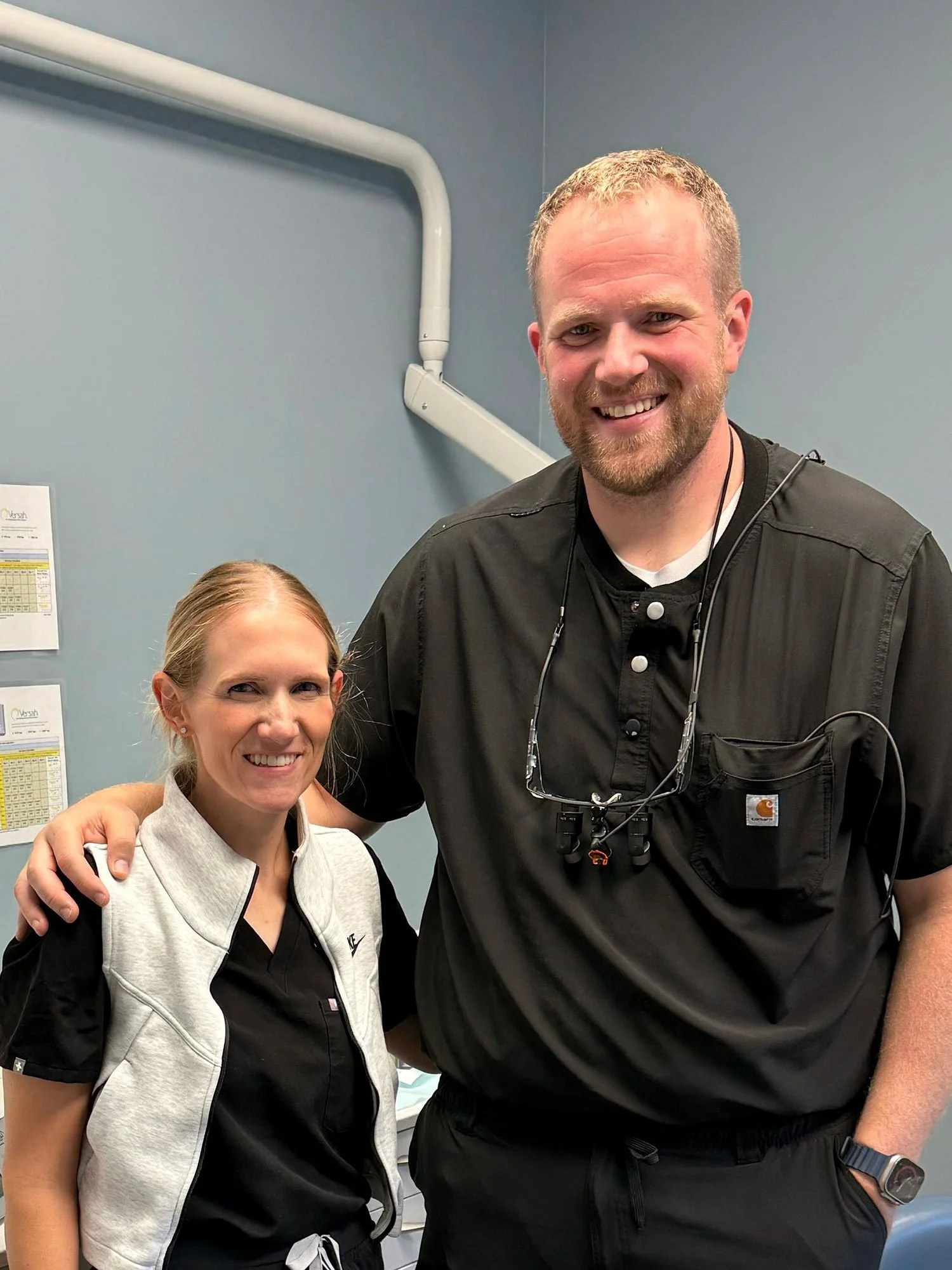 Dr. Holt of Parkview Dental Asheville in an exam room smiling with a smiling patient that underwent moderate IV sedation for her dental procedure
