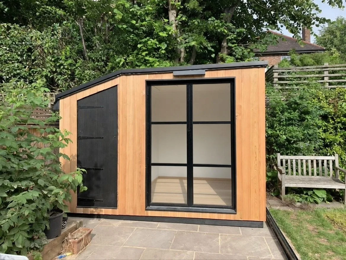 Small garden room with wooden exterior. Made in Crystal Palace, built in Herne Hill.