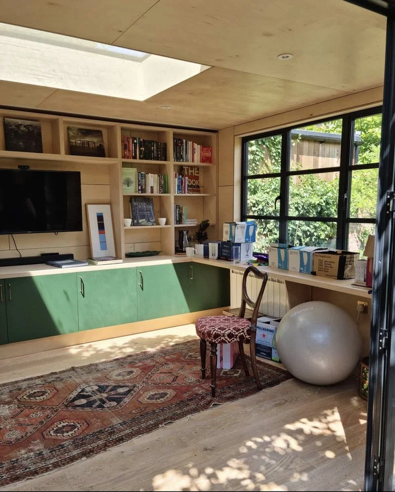 A cozy garden room/office space with painted birch plywood interior joinery. Made in Crystal Palace, built in Streatham.