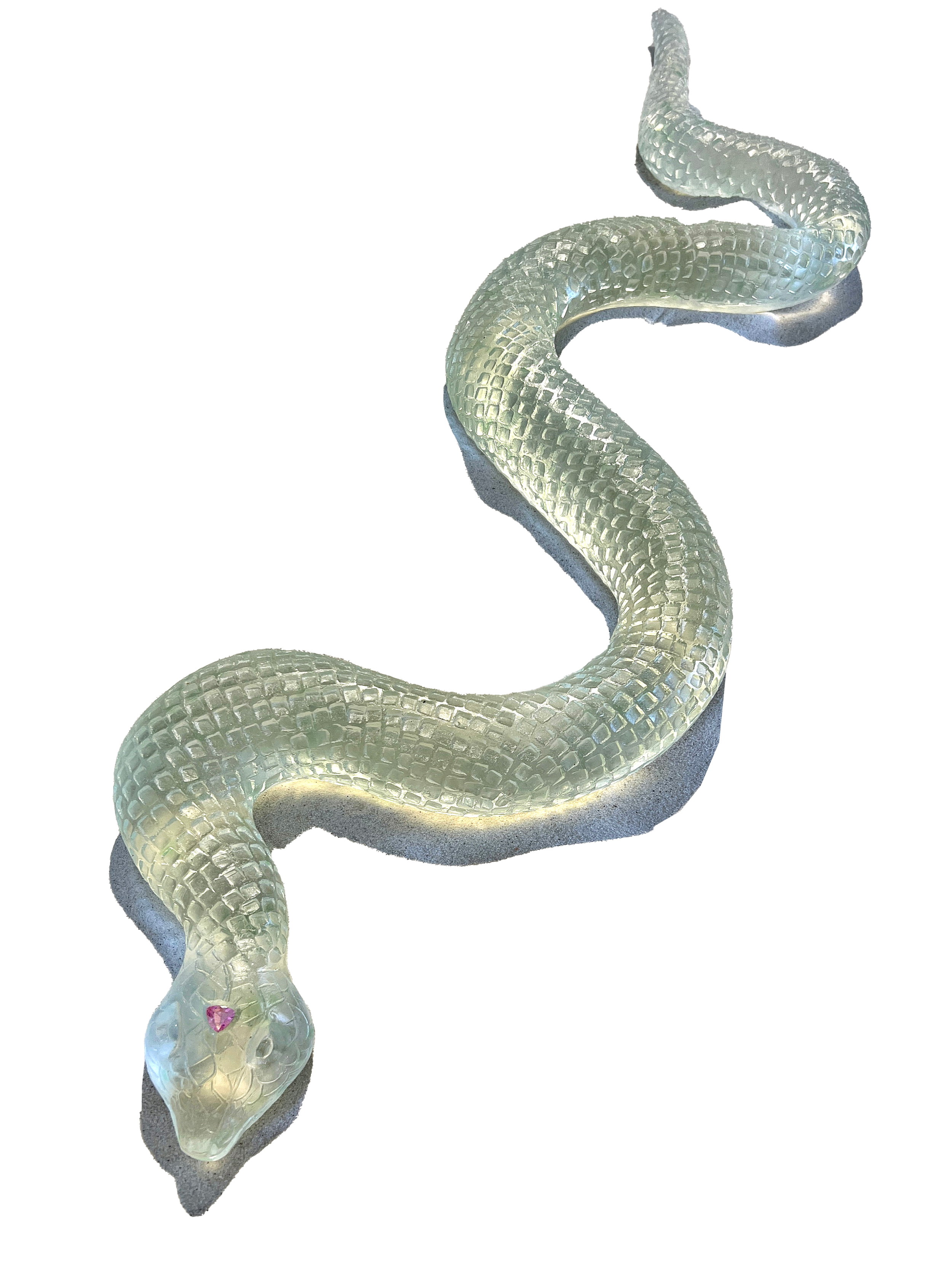 A decorative sculpture of a snake with a transparent, textured body and a pink gemstone on its head, coiled on a base.