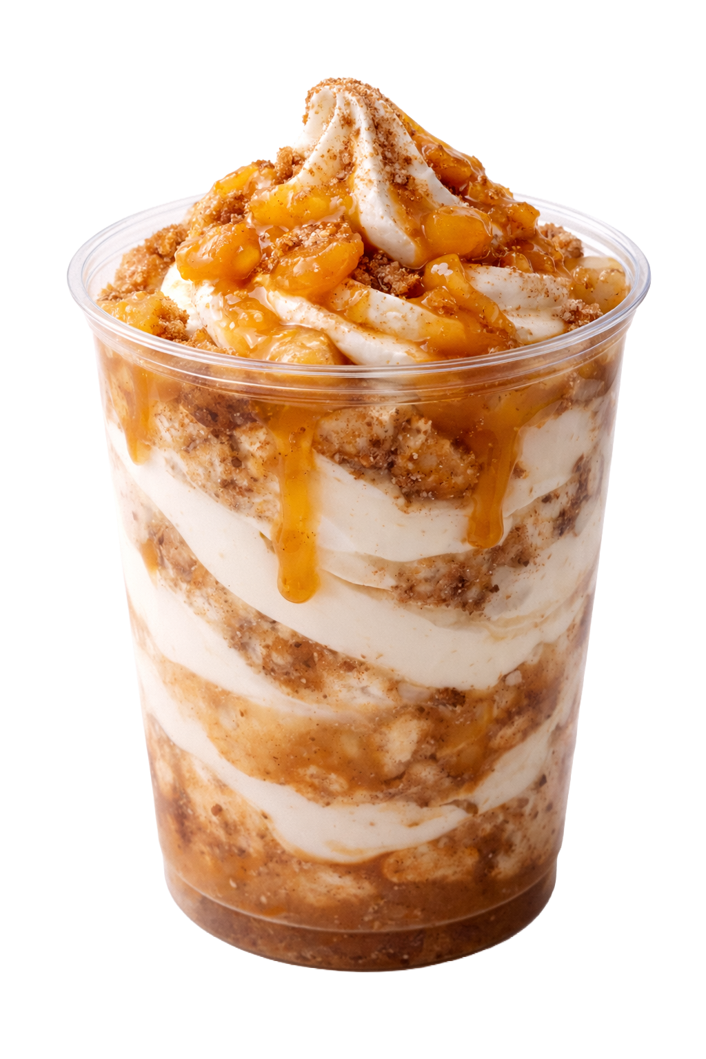 A close-up of a layered dessert in a clear plastic cup, with whipped cream, caramel sauce, and crumb topping.