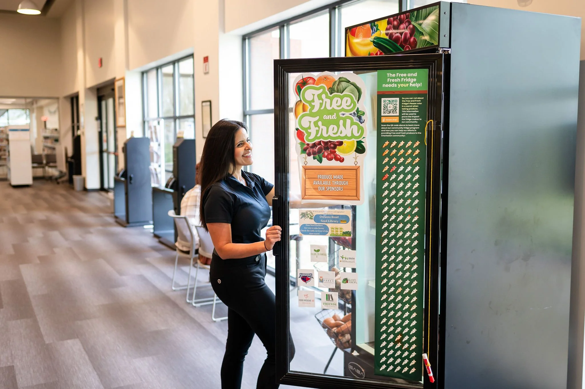 woman opening refrig door for free and fresh food program