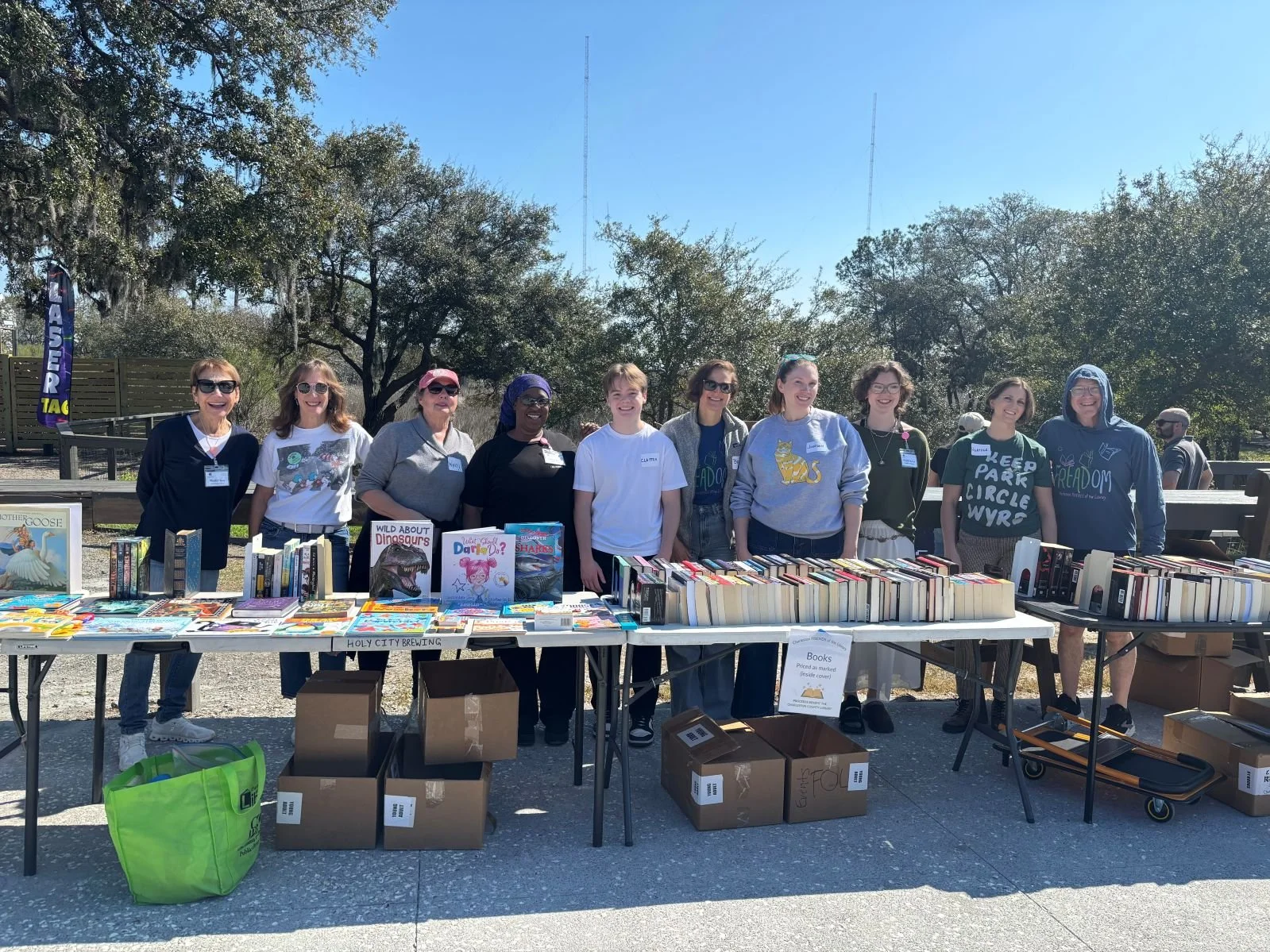 volunteers behind a table with books