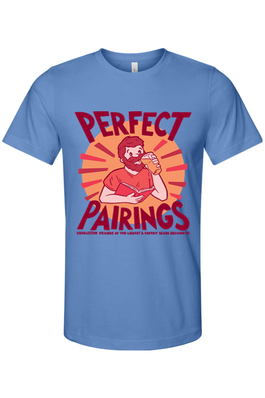Light blue t-shirt featuring a cartoon man with a beard, reading a book while drinking a beer, with the text 'Perfect Pairings' in bold red letters and additional small text at the bottom.