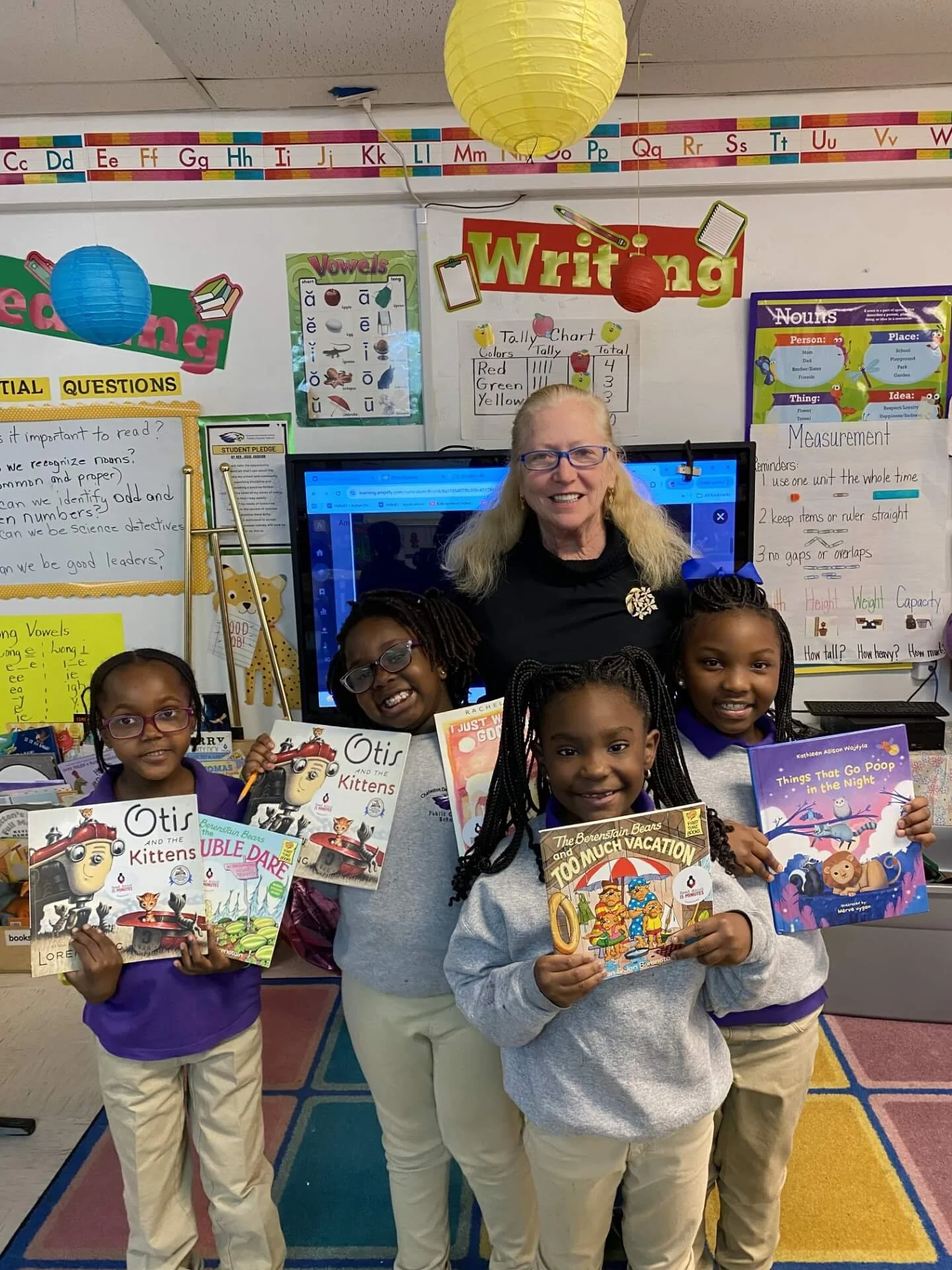 Teacher and students holding books