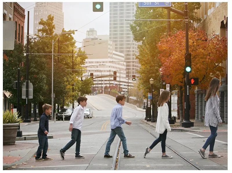 Group of children crossing a city street at a crosswalk