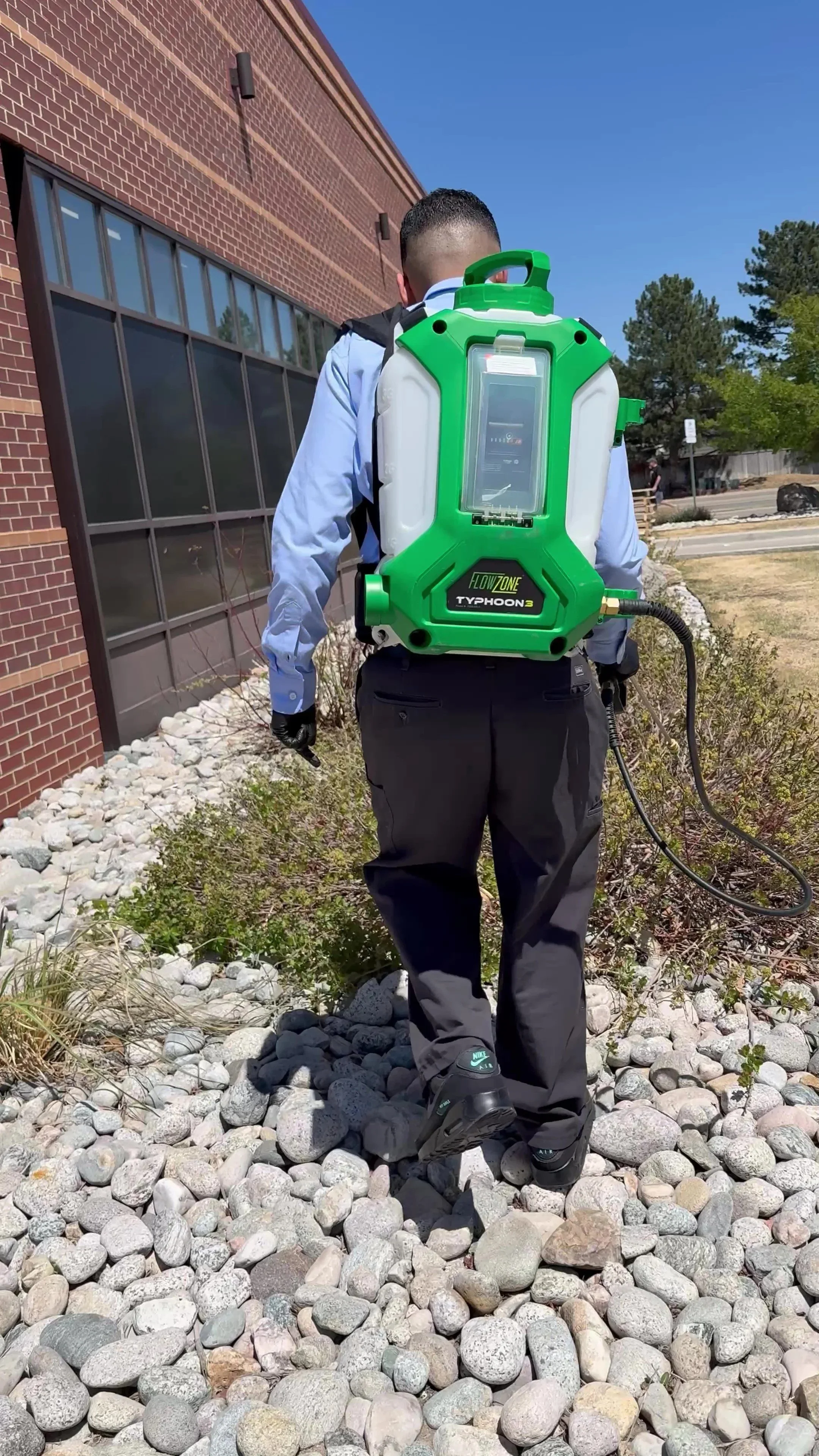 Apex Pest Management technician performing commercial pest control service at a Denver business property.