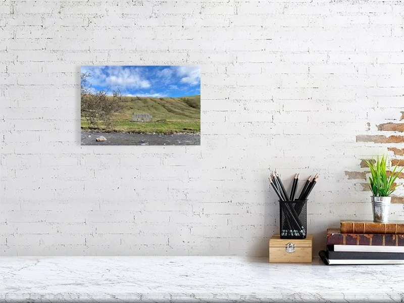 Sample print of a photograph of a stone cottage under a bright blue sky on the bank of the River Tilt in Scotland.