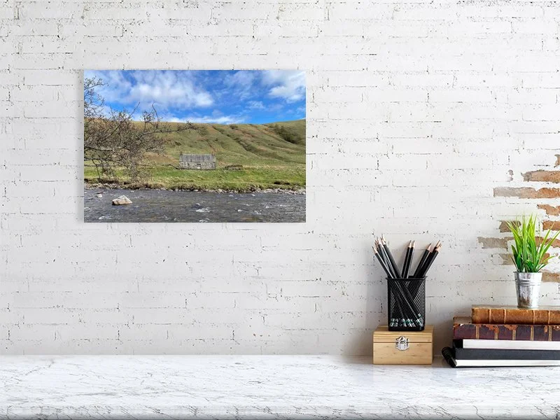Sample print of a photograph of a stone cottage under a bright blue sky on the bank of the River Tilt in Scotland.