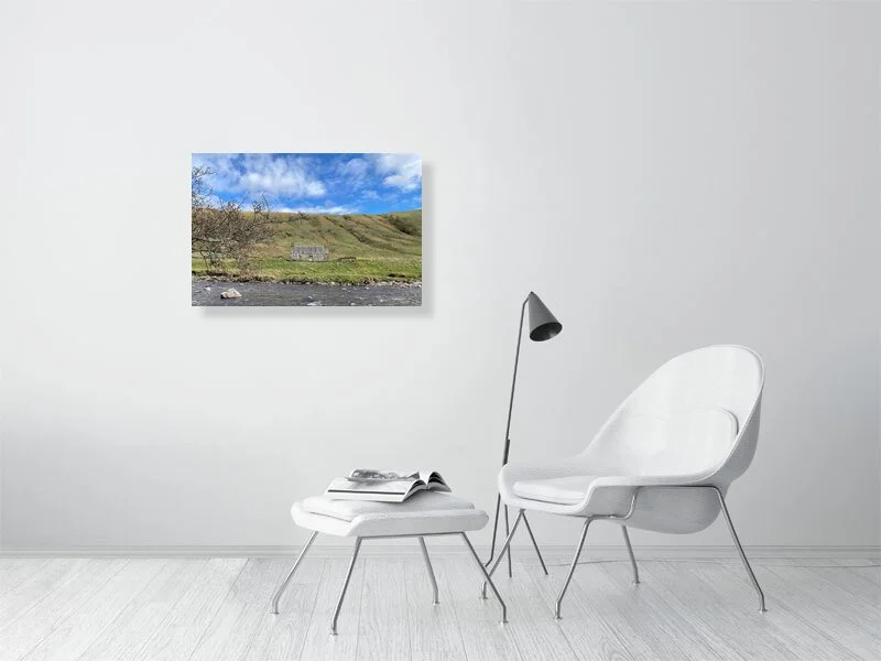 Sample print of a photograph of a stone cottage under a bright blue sky on the bank of the River Tilt in Scotland.