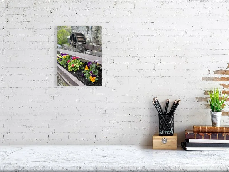 Fine art photograph of an antique wood and stone water mill waterwheel and a flower box taken in Scotland sample image.