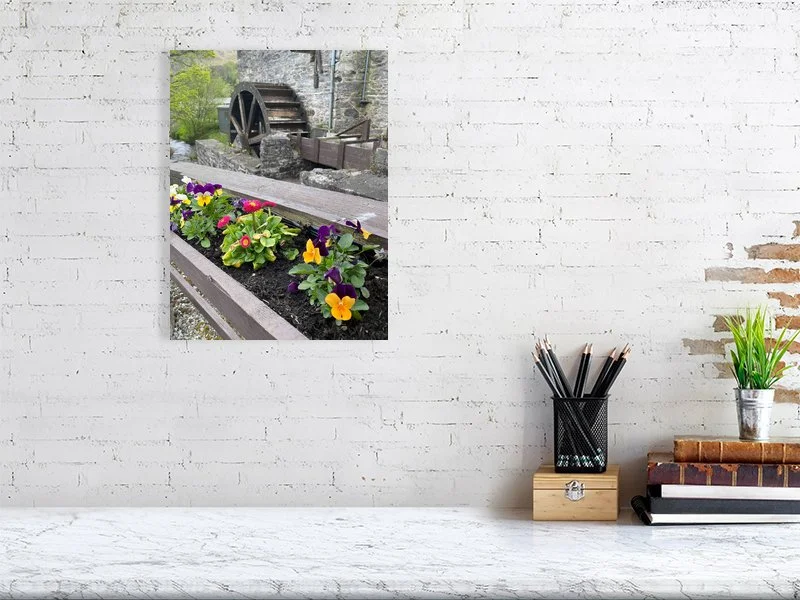 Fine art photograph of an antique wood and stone water mill waterwheel and a flower box taken in Scotland sample image.