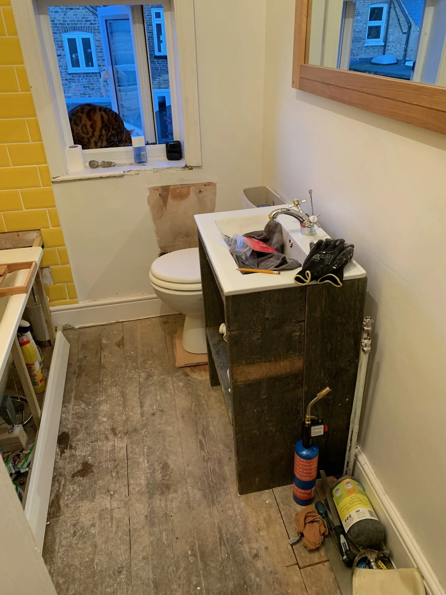 Bathroom Refurbishment Uxbridge. Rip out, relocate the toilet and sink. Light plumbing.