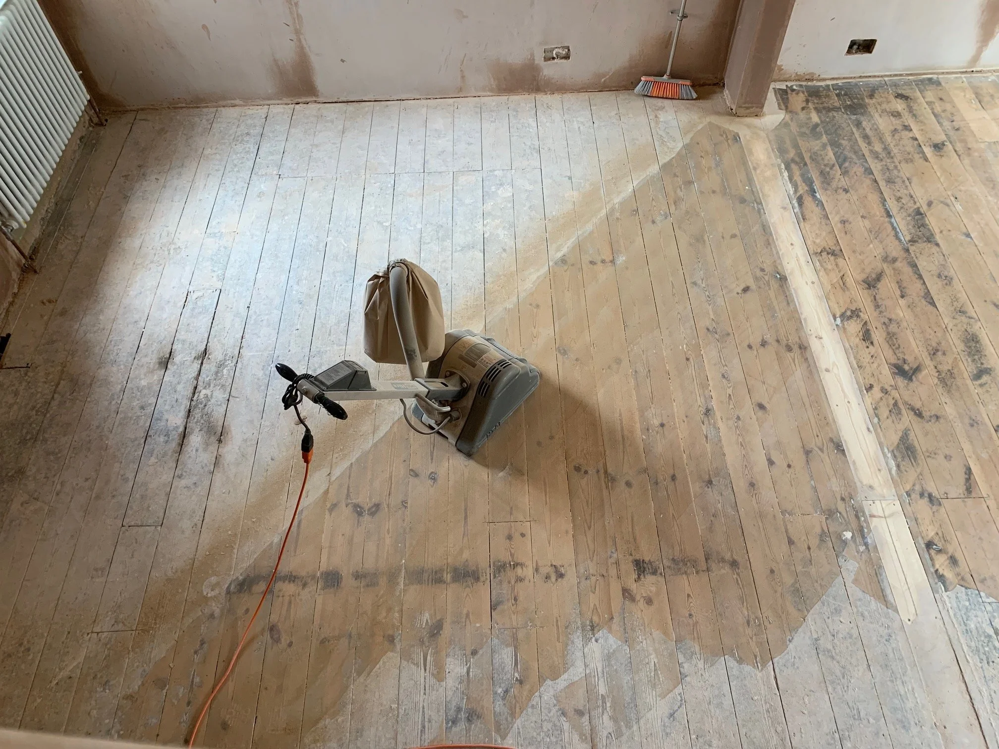 Living room redesign Uxbridge. A couple of walls were removed, leaving a large open plan room. The floors were all sanded and varnished initially. Interior design scheme was agreed and we went on to paint all the walls and cieling. Install coving and