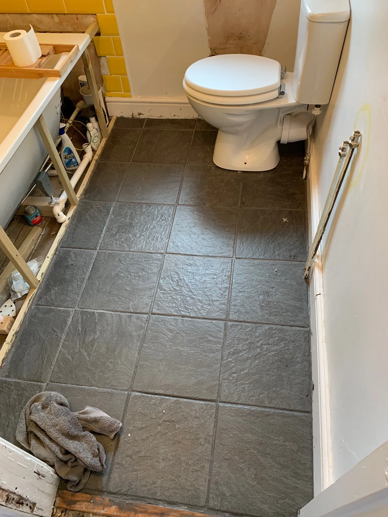 Bathroom Refurbishment Uxbridge. Rip out, relocate the toilet and sink. Light plumbing. Tiling.