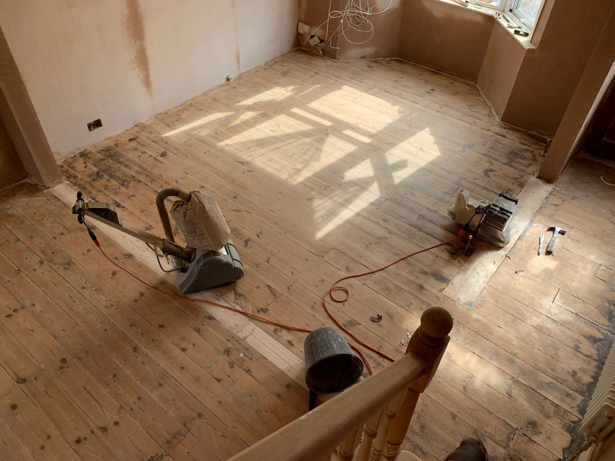 Living room redesign Uxbridge. A couple of walls were removed, leaving a large open plan room. The floors were all sanded and varnished initially. Interior design scheme was agreed and we went on to paint all the walls and cieling. Install coving and