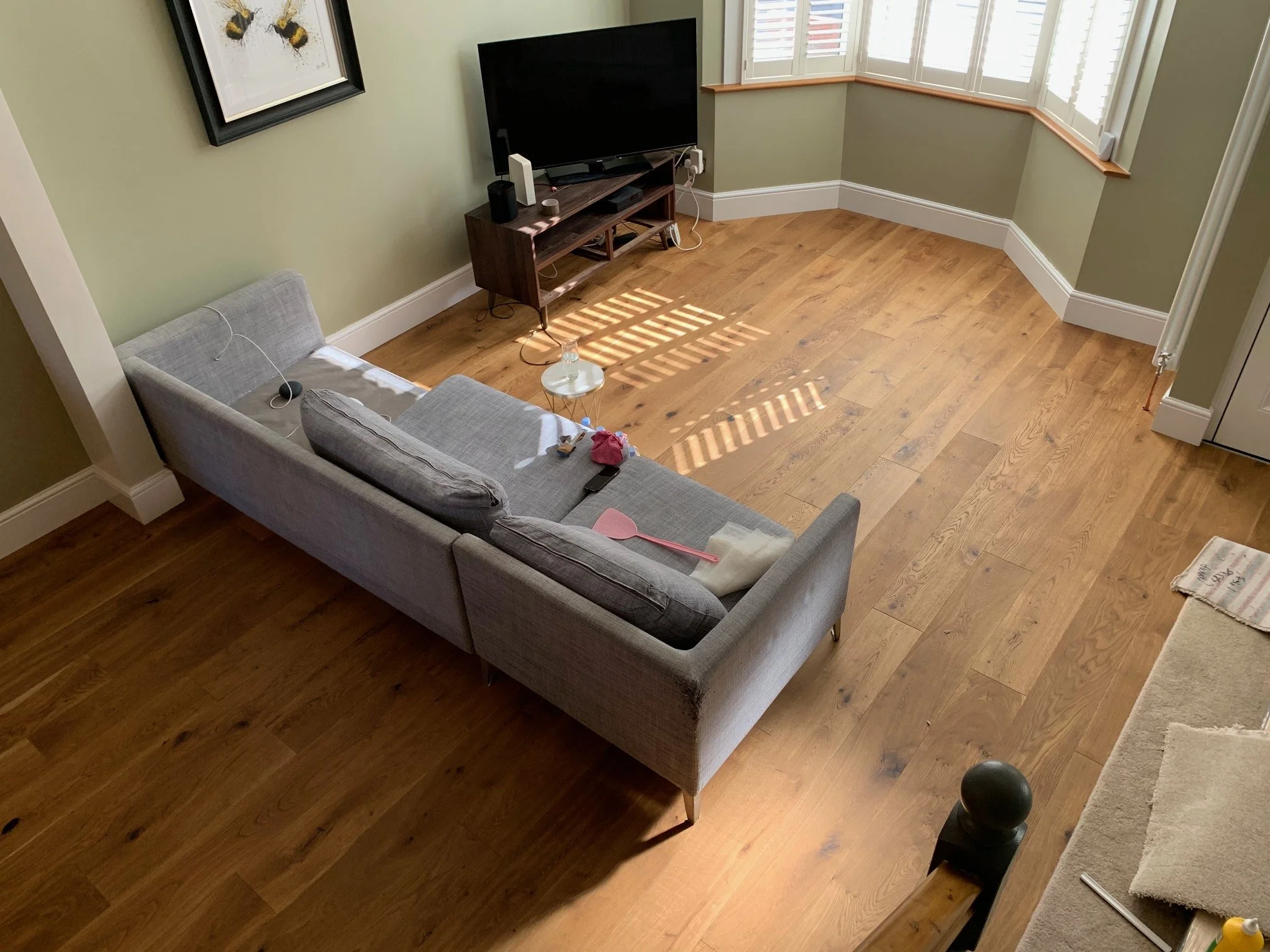 Living room redesign Uxbridge. A couple of walls were removed, leaving a large open plan room. The floors were all sanded and varnished initially. Interior design scheme was agreed and we went on to paint all the walls and cieling. Install coving and