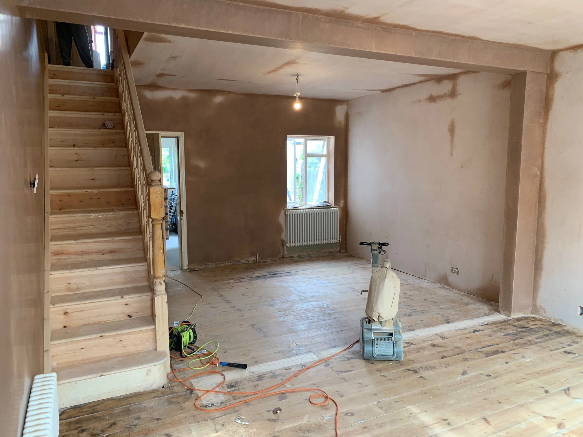 Living room redesign Uxbridge. A couple of walls were removed, leaving a large open plan room. The floors were all sanded and varnished initially. Interior design scheme was agreed and we went on to paint all the walls and cieling. Install coving and