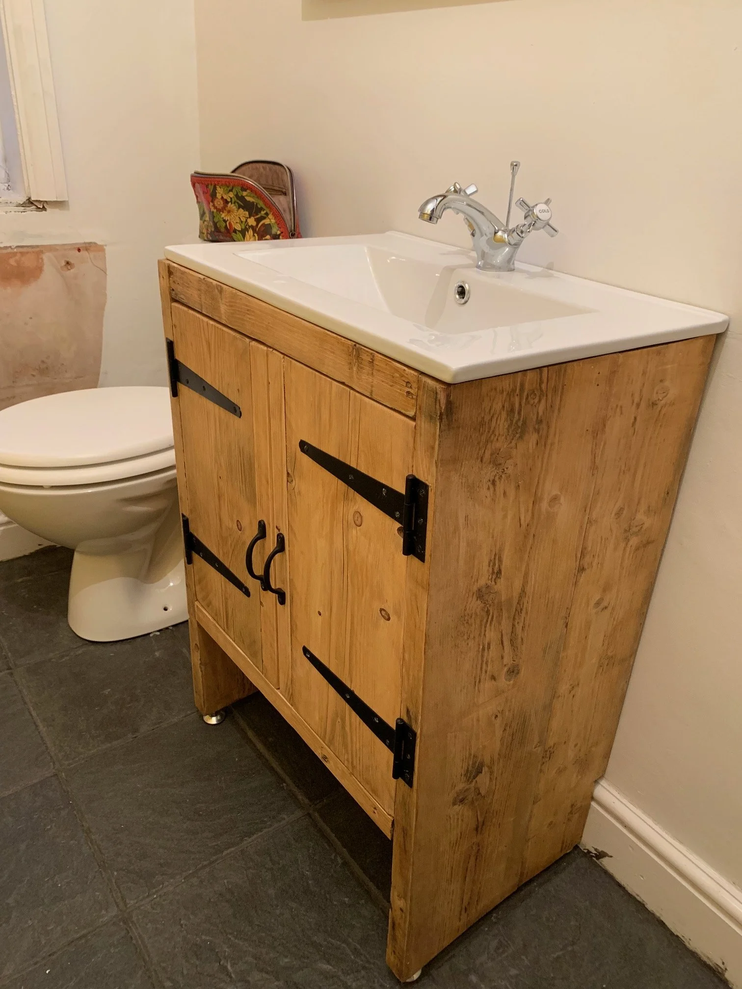 Bathroom Refurbishment Uxbridge. Rip out, relocate the toilet and sink. Light plumbing. Tiling. Custom sink unit.